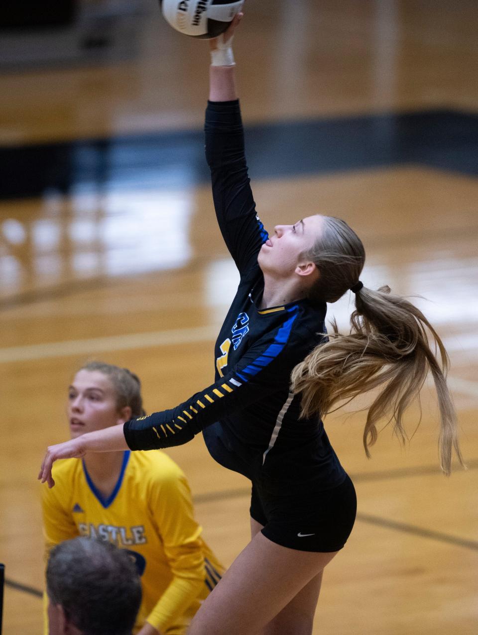 Castle’s Katie Kopshever (2) spikes the ball as the Castle Knights play the North Huskies during the IHSAA Class 4A Volleyball Sectional championship in Jasper, Ind., Saturday, Oct. 14, 2023.