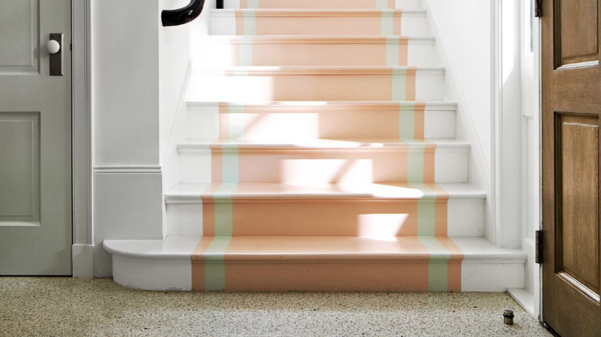 a white staircase with a basket on it