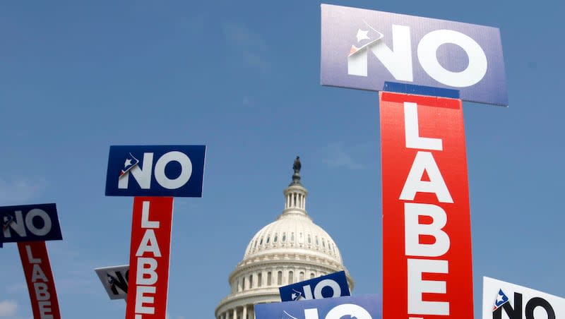 People with the group No Labels hold signs during a rally on Capitol Hill in Washington, July 13, 2013. The third-party presidential movement No Labels plans to meet on March 8, 2024, amid fierce pressure on donors and potential candidates from Donald Trump critics who fear the deep-pocketed group would help the former president return to the White House. No Labels Chief Strategist Ryan Clancy says no candidates will be selected at the meeting.