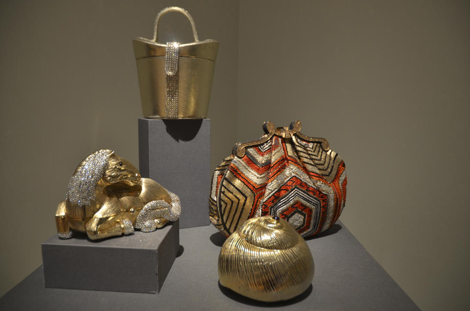 Various handbags by Hungarian designer Judith Leiber, counter clockwise from left, Gold Horse Minaudière with Jet Eyes and rhinestones, Gold Seashell Shaped Minaudière with ruby details, Obi Fabric with rhinestones re-embroidery and a rhinestone frame, and Gold Kid Hatbox with crystal rhinestones on the handle and strap, are displayed at the Leiber Collection in East Hampton, N.Y., on Saturday, Sept. 17, 2022. (AP Photo/Pamela Hassell)