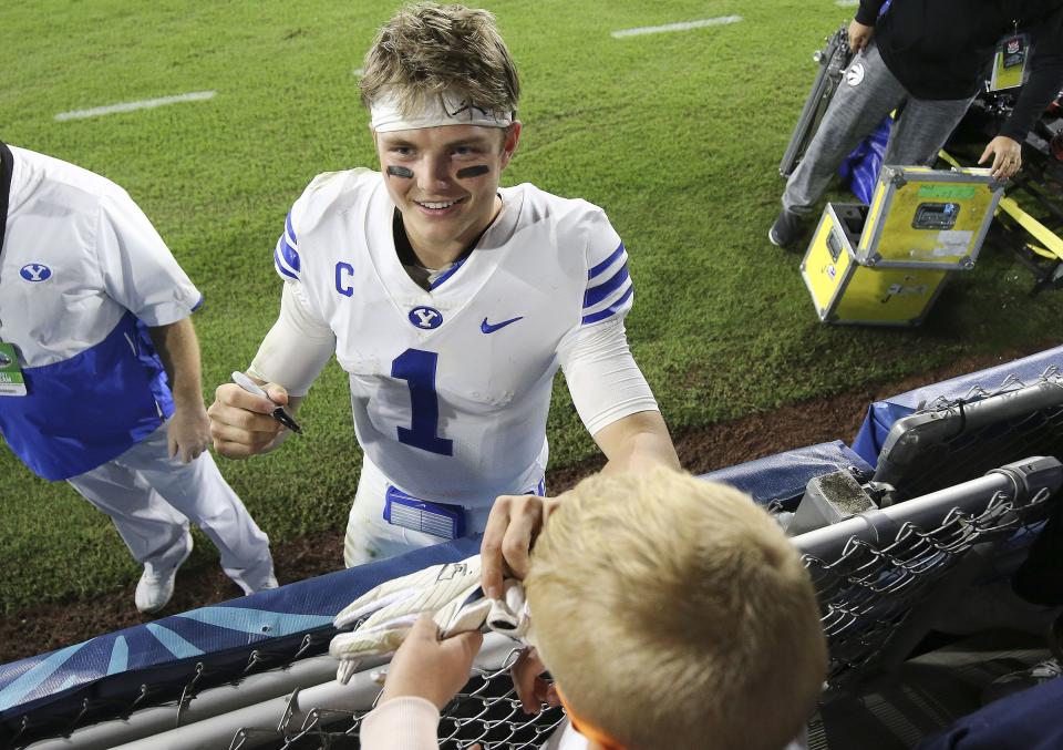 Brigham Young Cougars quarterback Zach Wilson (1) signs an autograph for a young fan after the Boca Raton Bowl in Boca Raton, Fla., on Tuesday, Dec. 22, 2020. BYU won 49-23. | Jeffrey D. Allred, Deseret News