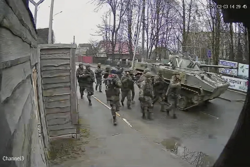 In this image from surveillance video, Russian troops take over Yablunska Street in Bucha, Ukraine on March 3, 2022, where they set up a headquarters during their month-long occupation. When Russian troops crossed from Belarus into Ukraine in late February, pressing toward Kyiv, they were ordered to block and destroy “nationalist resistance,” according to the Royal United Services Institute, a London think tank that has reviewed copies of Russia’s battle plans. (AP Photo)