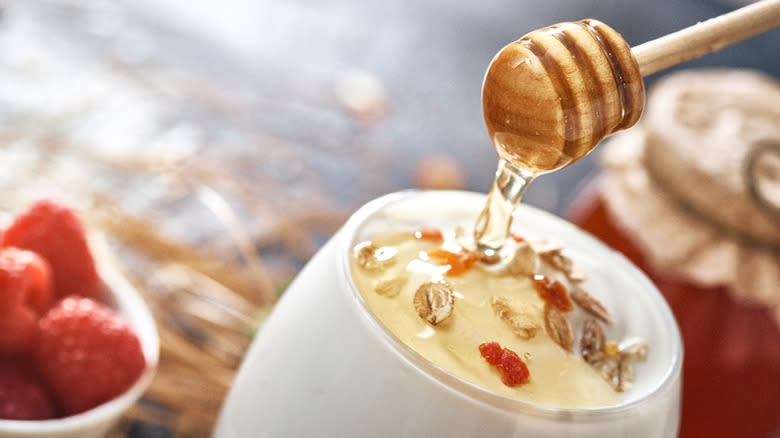 greek yogurt with honey and granola in cup