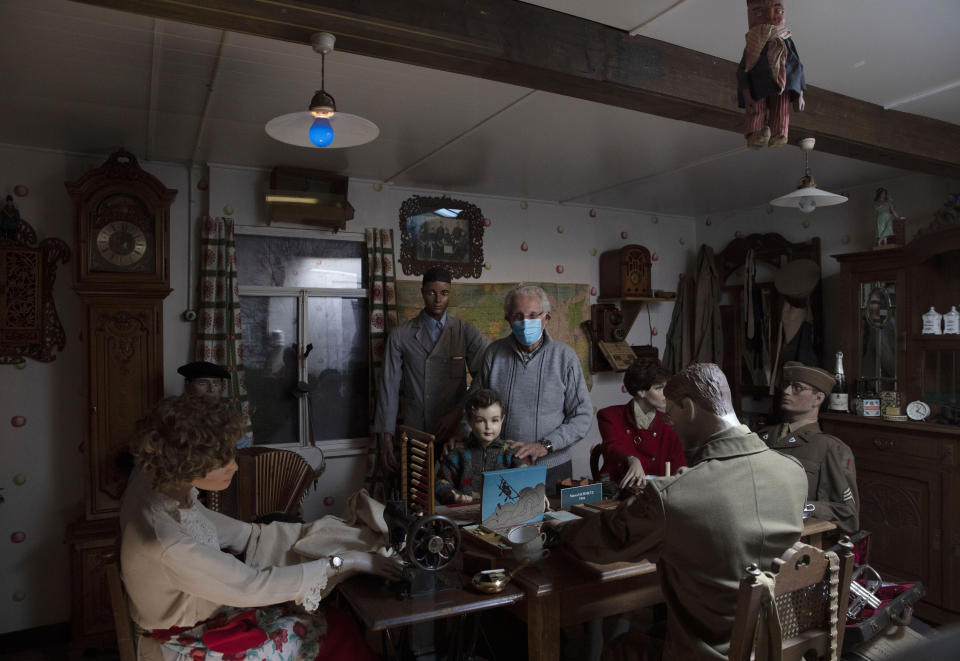 In this photo taken on Tuesday, May 5, 2020, director of the Remember Museum 39-45, Marcel Schmetz, stands in a room re-created from his childhood kitchen during World War II in Thimister-Clermont, Belgium. Schmetz now runs a war museum with his wife Mathilde, right where the Battle of the Bulge, Hitler's last stand to change the tide of the war, took place. But what was supposed to be the highlight of the year is now spent in isolation with Mathilde behind closed doors of the museum. (AP Photo/Virginia Mayo)