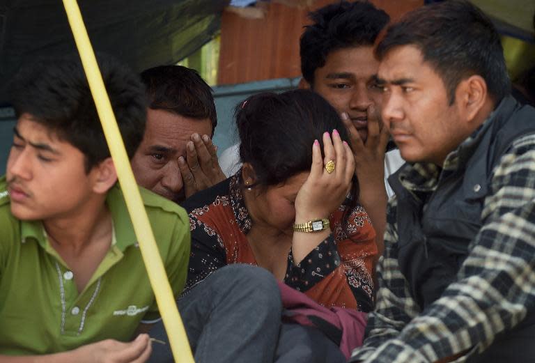 Nepalese residents cry as police retrieve the bodies of relatives Chandrawati Mahat and Prasamsah during rescue efforts in the Balaju neighbourhood of Kathmandu, on April 27, 2015