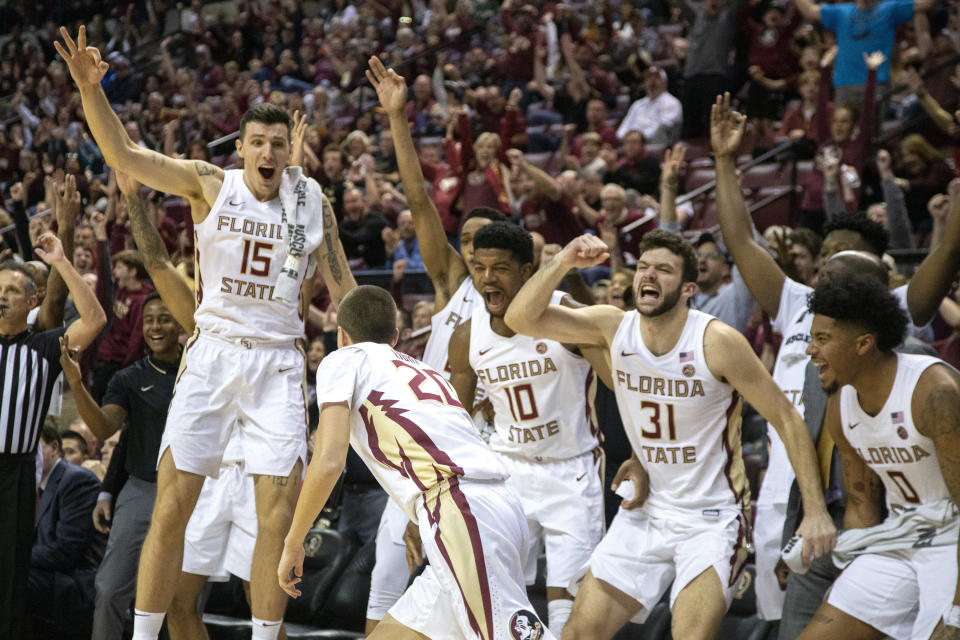 Florida State players celebrate after guard Travis Light (20) hitting two 3-pointers in the final minute of an NCAA college basketball game against Miami in Tallahassee, Fla., Saturday, Feb. 8, 2020. Florida State defeated Miami 99-81. (AP Photo/Mark Wallheiser)