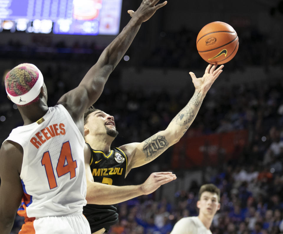 Missouri guard Tre Gomillion (2) tries for a shot against Florida guard Kowacie Reeves (14) during the first half of an NCAA college basketball game Saturday, Jan. 14, 2023, in Gainesville, Fla. (AP Photo/Alan Youngblood)