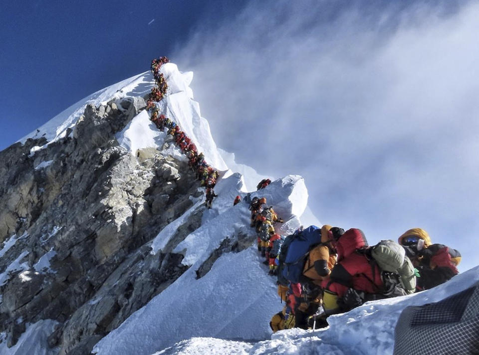 In this photo made on May 22, 2019, a long queue of mountain climbers line a path on Mount Everest. About half a dozen climbers died on Everest last week most while descending from the congested summit during only a few windows of good weather each May. (Nirmal Purja/@Nimsdai Project Possible via AP)