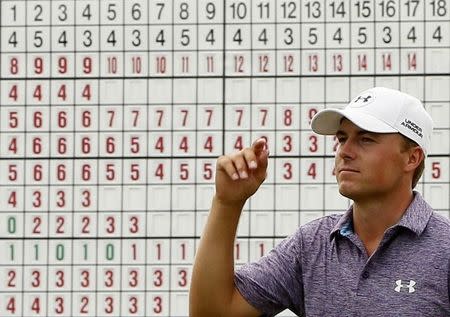 Jordan Spieth walks off the 18th green at 14-under par. (REUTERS)