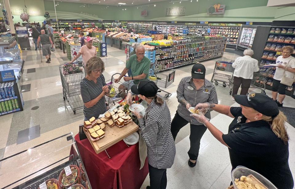 Kroger customers enjoy free samples Friday morning during the Ashland Road location's Grand Re-opening.