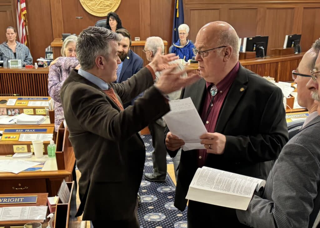 Rep. Andrew Gray, D-Anchorage, gestures with his hands as he talks to Rep. Kevin McCabe, R-Big Lake, about an amendment to raise the state's age of consent to 18, Friday, March 22, 2024, in the Alaska House of Representatives. (Photo by James Brooks/Alaska Beacon)