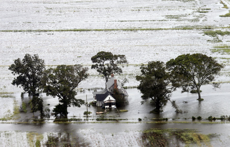 A farm house is surrounded by flooded fields from tropical storm Florence in Hyde County, N.C., Saturday, Sept. 15, 2018. (AP Photo/Steve Helber)