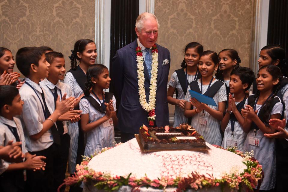 Britain's Prince Charles interacts with children from the Kaivalya Education Foundation supported by the British Asian trust, in Mumbai on Nov. 14, 2019.