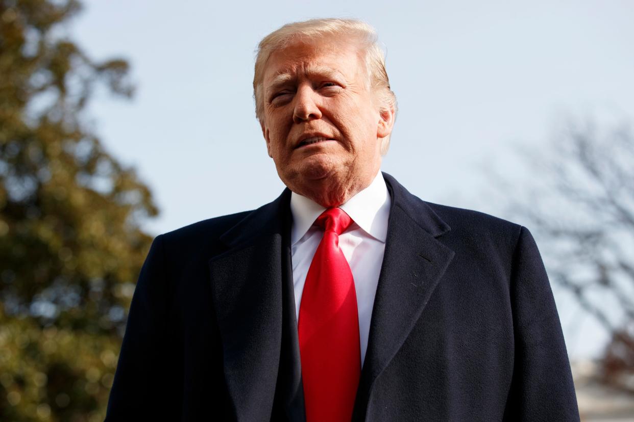 President Donald Trump is pictured talking to reporters outside the White House.