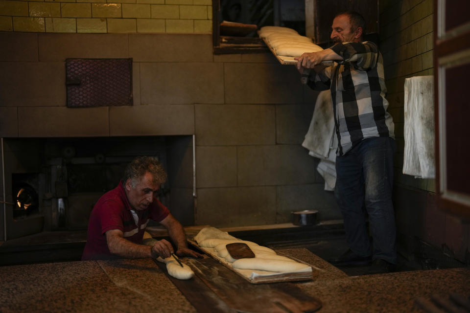 Workers bake loaves of bread in Istanbul, Turkey, Monday, June 19, 2023. The Turkish central bank faces a key test Thursday June 22, 2023, on turning to more conventional economic policies to counter sky-high inflation after newly reelected President Recep Tayyip Erdogan gave mixed signals about an approach that many blame for worsening a cost-of-living crisis. (AP Photo/Francisco Seco)