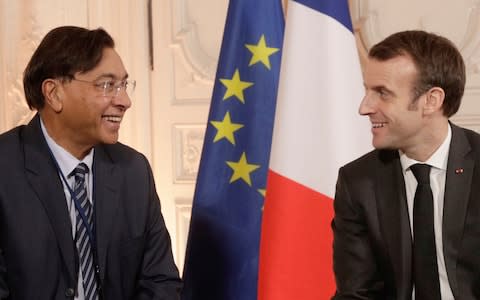 Chairman and CEO of ArcelorMittal Lakshmi Mittal, left, speaks with French President Emmanuel Macron at the "Choose France" summit - Credit: AFP