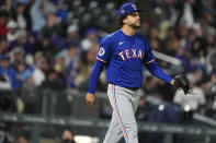 Texas Rangers relief pitcher Yerry Rodríguez reacts after giving up a double to Colorado Rockies' Charlie Blackmon to allow in two runs in the eighth inning of a baseball game Friday, May 10, 2024, in Denver. (AP Photo/David Zalubowski)