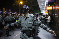 Riot Police petrol with face mask in the Tsim Sha Tsui district in Hong Kong, Thursday, Oct. 10, 2019. A Hong Kong government official said on Thursday that Apple was responsible for removing a smartphone application which allowed activists to report police movements. (AP Photo/Kin Cheung)