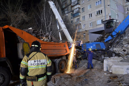 Russian Emergencies Ministry members work at the site of a partially collapsed apartment block in Magnitogorsk, Russia in this handout photo released by Russian Emergencies Ministry January 1, 2019. Russia's Ministry for Civil Defence, Emergencies and Elimination of Consequences of Natural Disasters/Handout via REUTERS
