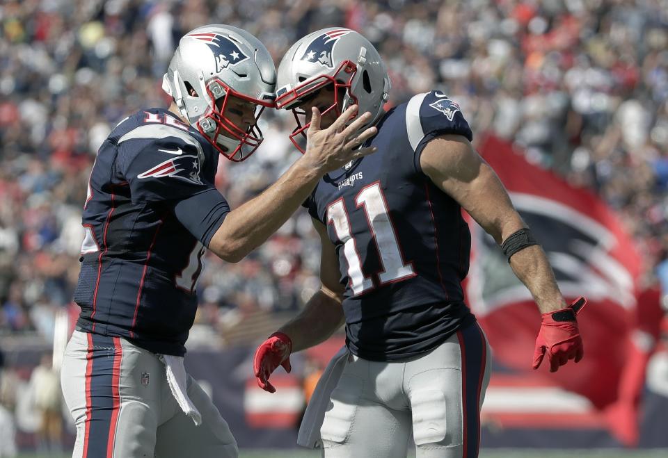 New England Patriots quarterback Tom Brady, left, celebrates his touchdown pass to Julian Edelman, right, in the first half of an NFL football game against the New York Jets, Sunday, Sept. 22, 2019, in Foxborough, Mass. (AP Photo/Elise Amendola)