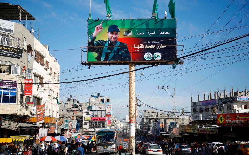 A billboard displays a picture of one Mazen Faqha after he was shot dead in Gaza City.  - Credit: FP PHOTO / MOHAMMED ABED