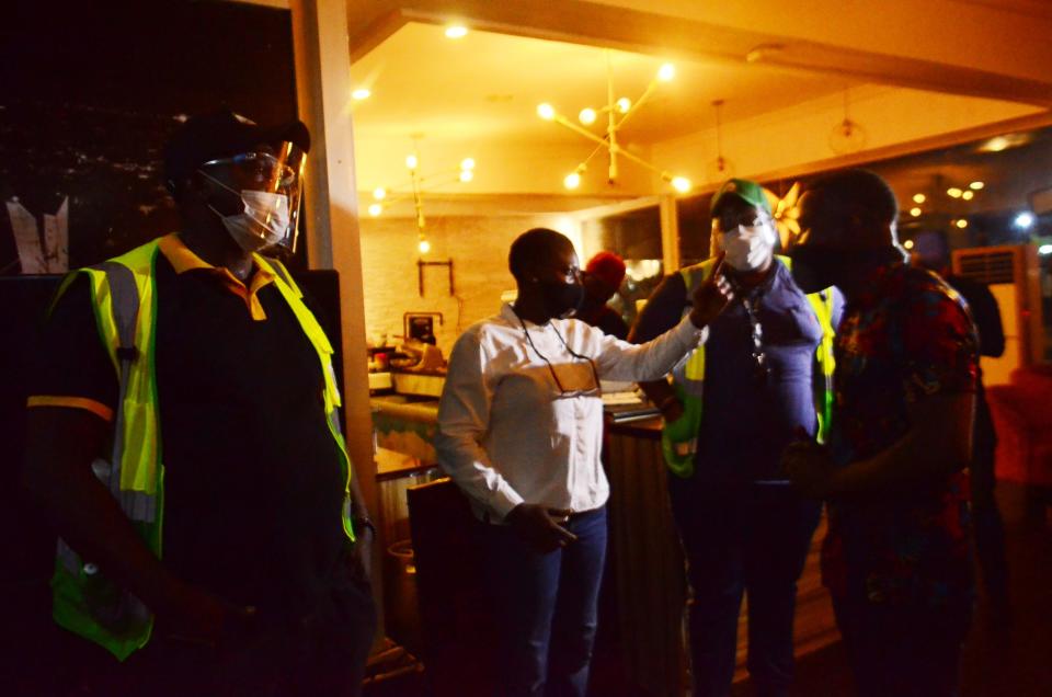 Officials of Lagos State Environmental Protection Agency discussing with manager of a bar/restaurants while inspecting/seal off hospitality business violators on July 19, 2020. In monitoring level of compliance giving by the government with the safety measures to curtail the spread of COVID-19 coronavirus in the country. (Photo by Olukayode Jaiyeola/NurPhoto via Getty Images)