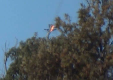 A war plane crashes in flames in a mountainous area in northern Syria after it was shot down by Turkish fighter jets near the Turkish-Syrian border November 24, 2015. Turkish fighter jets shot down a Russian-made warplane near the Syrian border on Tuesday after repeatedly warning it over air space violations, Turkish officials said, but Moscow said it could prove the jet had not left Syrian air space. REUTERS/Sadettin Molla