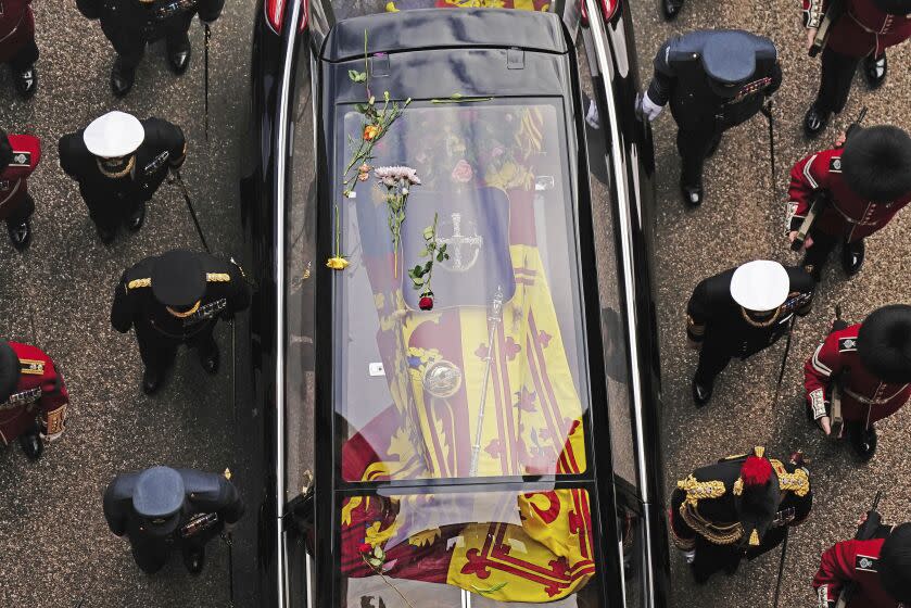 Flowers on the hearse carrying the coffin of Queen Elizabeth II as it arrives at Windsor Castle for the Committal Service in St George's Chapel, in Windsor, England, Monday, Sept. 19, 2022. (Aaron Chown/Pool photo via AP)