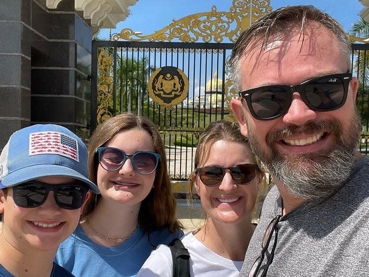 A picture of Tiffany Werner and her family outside the King's palace in KL.