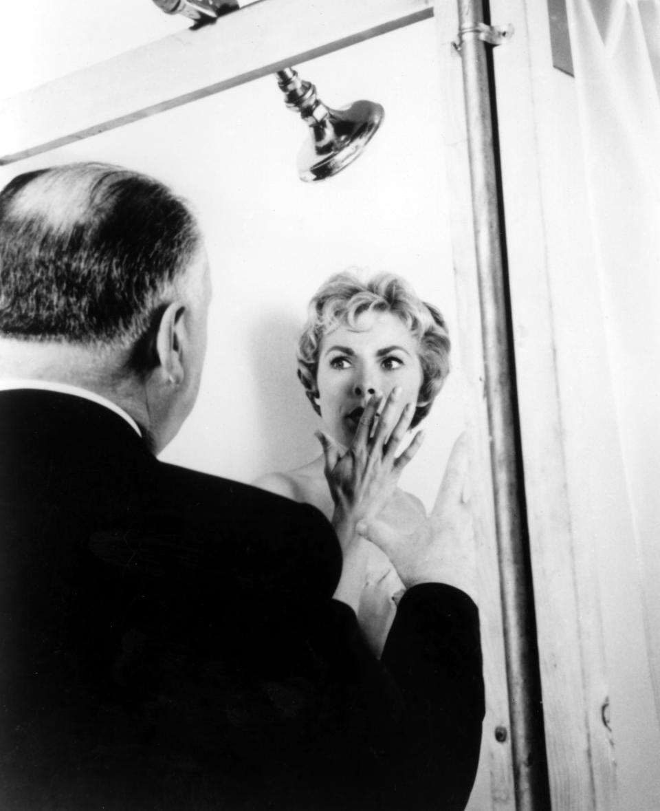 Alfred Hitchcock directs Janet Leigh in the iconic shower scene from the film "Psycho."