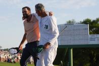 Scottie Scheffler celebrates with his caddie Ted Scott after winning the Masters golf tournament at Augusta National Golf Club Sunday, April 14, 2024, in Augusta, Ga. (AP Photo/David J. Phillip)