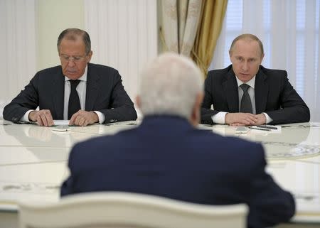 Russian President Vladimir Putin (R), Foreign Minister Sergei Lavrov (L) and Syrian Foreign Minister Walid al-Muallem (back to camera) attend a meeting at the Kremlin in Moscow, Russia, June 29, 2015. REUTERS/Alexei Nikolsky/RIA Novosti/Kremlin