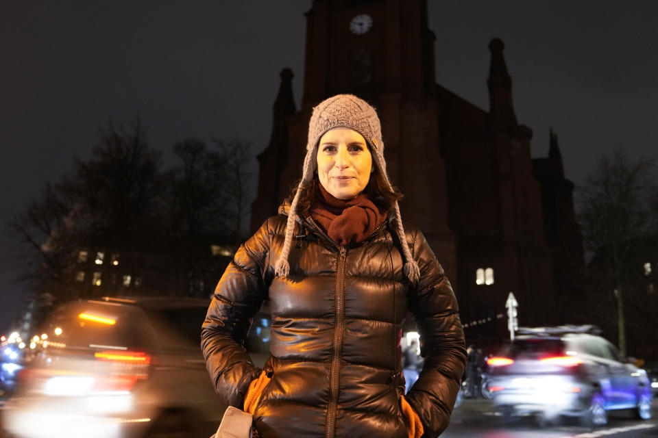 Actress Stefanie Hoener poses for a photo as she attends a counter-rally against anti-vaccination activists in front of the Gethsemane Church in Berlin, Germany, Monday, Jan. 24, 2022. A growing number of Germans have recently joined grassroots initiatives, local groups and spontaneous demonstrations to speak out against vaccination opponents, conspiracy theorists and far-right extremists who have led protests against COVID-19 measures in Germany. (AP Photo/Markus Schreiber)