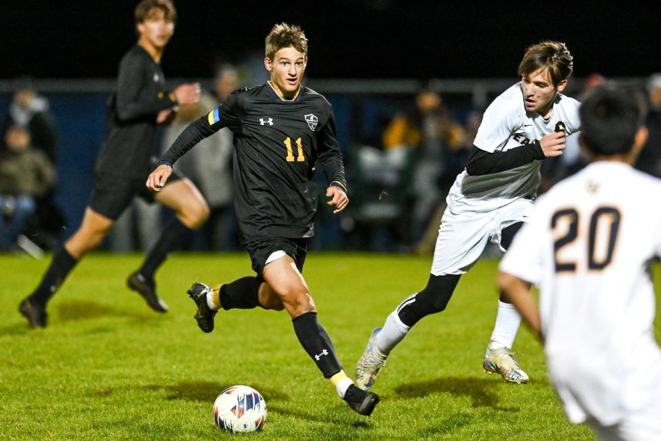 DeWitt's Ruslan Masalitin moves with the ball against Eastern during the second half on Thursday, Oct. 20, 2022, at DeWitt High School.