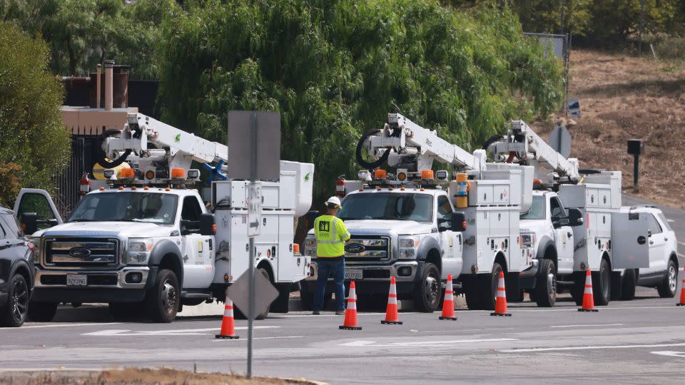 Utility trucks line up in Rancho Palos Verdes, California, as land movement in the area threatens power lines. - David Swanson/Reuters