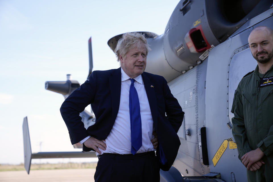 Prime Minister Boris Johnson (left) meets crews and technical staff during a visit to Lydd airport in Kent. Picture date: Thursday April 14, 2022.