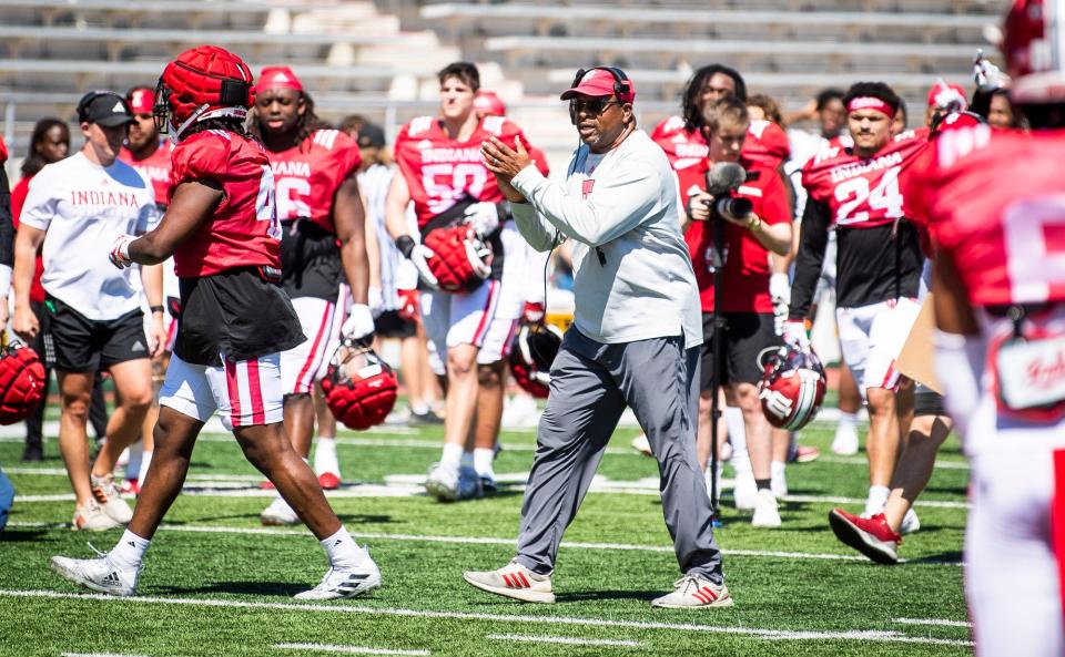 Indiana defensive line coach Paul Randolph congratulates the defense on winning the scrimmage during Indiana football's Spring Football Saturday event at Memorial Stadium on Saturday, April 15, 2203.