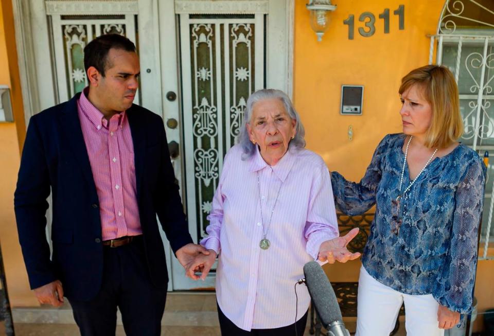 Ana Lazara Rodriguez, 82, center, surrounded by Eleazar Melendez, left, and Laura Wagner, right, speaks during a press conference outside of her home in Miami, Florida on Thursday, May 6, 2021.