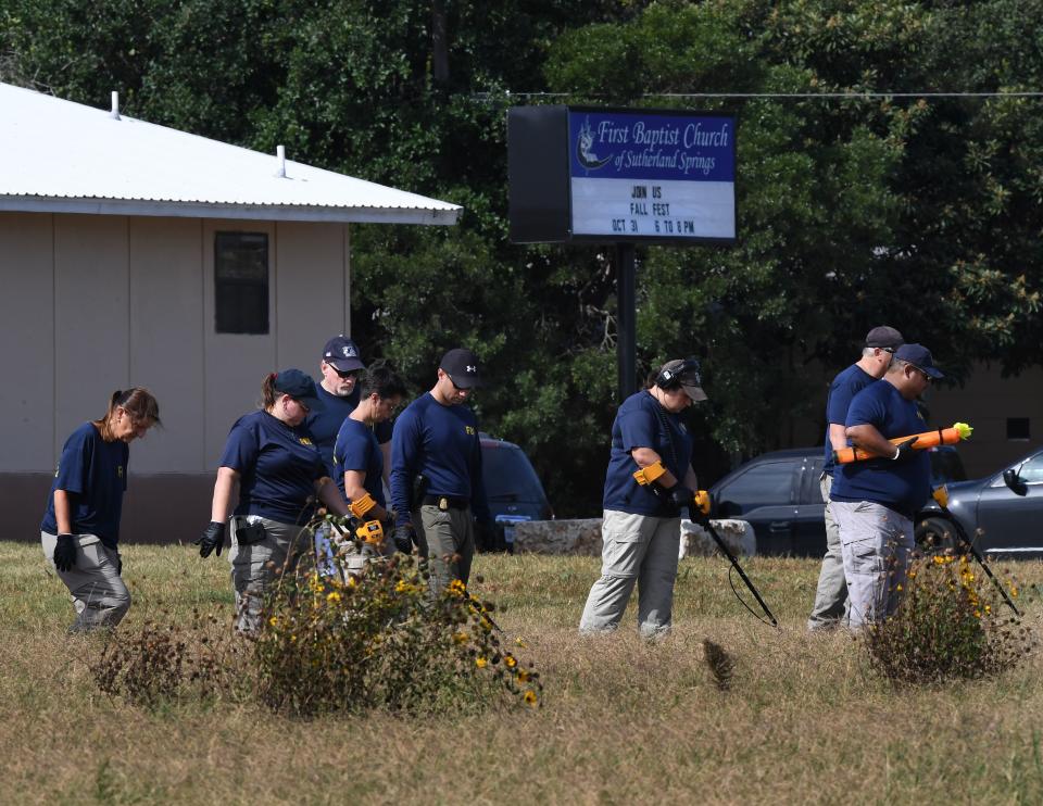 FBI agents search for clues on Monday at the entrance to the First Baptist Church, after the mass shooting in Sutherland Springs. (Photo: Mark Ralston/AFP/Getty Images)