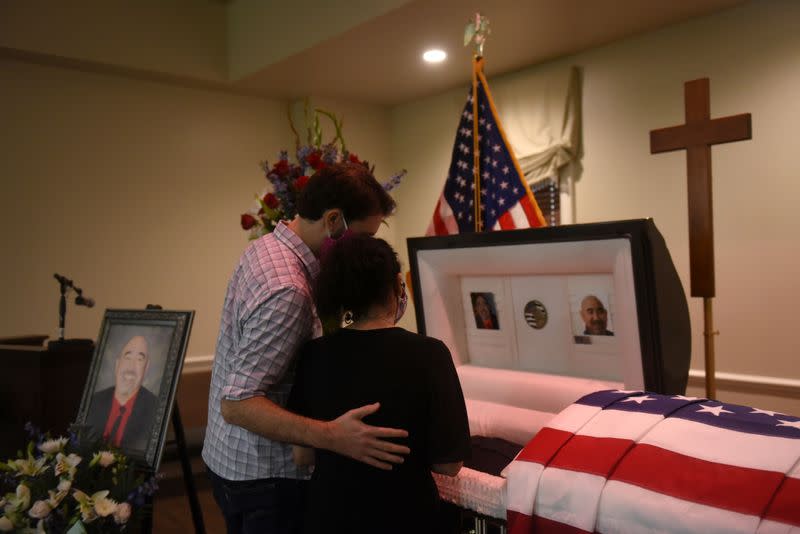 Mourners attend a funeral for a Texas man who died of COVID-19