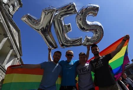 Same-sex marriage supporters pose for a photograph at Dublin Castle in Dublin, Ireland May 23, 2015. REUTERS/Cathal McNaughton