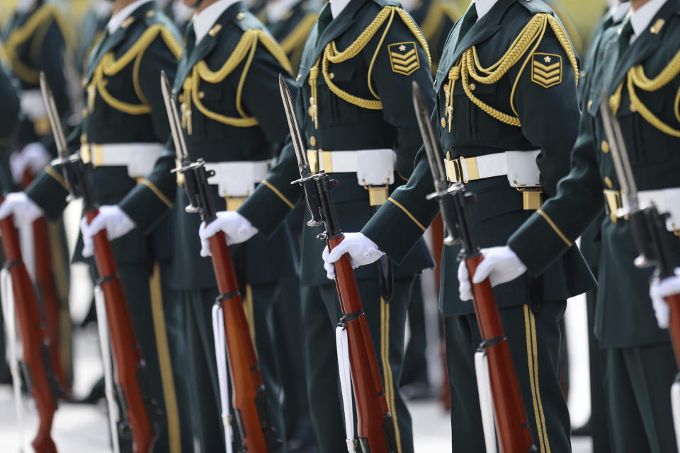 Members of a Japanese Self Defense Force honor guard prepare to be inspected by U.S. Secretary of Defense Chuck Hagel at the Defense Ministry in Tokyo, Sunday, April 6, 2014. Against the backdrop of Russia's takeover of Ukraine's Crimean region, Hagel said Saturday he will convey to Japanese leaders that the U.S. is strongly committed to protecting their country's security. (AP Photo/Eugene Hoshiko)