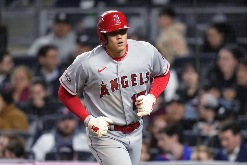 Los Angeles Angels' Shohei Ohtani heads to the dugout after scoring on a sacrifice fly by Anthony Rendon during the fifth inning of the team's baseball game against the New York Yankees on Tuesday, April 18, 2023, in New York. (AP Photo/Frank Franklin II)