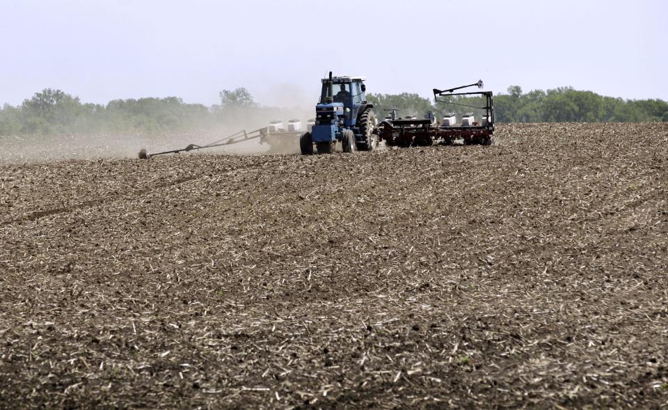 Andy Hall plants corn in a field, Thursday, May 10, 2012, near Bondurant, Iowa. The U.S. Department of Agriculture estimates a record corn crop this year, topping the previous high by 11 percent.(AP Photo/Charlie Neibergall)
