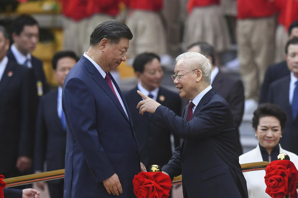 China's President Xi Jinping, center left, and Vietnam's Communist Party General Secretary Nguyen Phu Trong, center right, attend a welcome ceremony at the Presidential Palace in Hanoi, Vietnam, Tuesday Dec. 12, 2023. (Nhac Nguyen/Pool via AP)