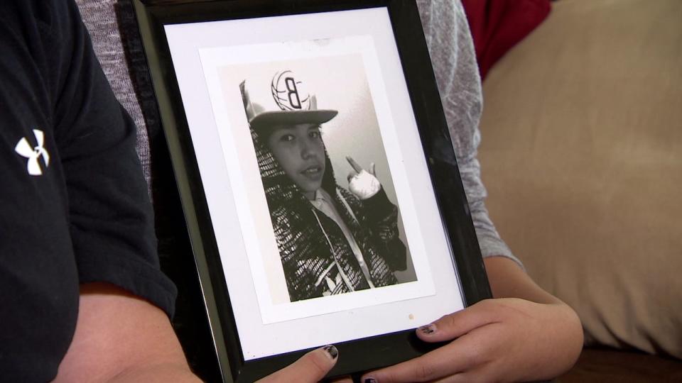 Family members hold a picture of Haven, 14, who was found dead in a creek on May 20, 2015.