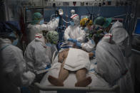 A COVID-19 patient receives treatment in the ICU of the Hospital del Mar, in Barcelona, Spain, Tuesday, Jan. 19, 2021. The unrelenting increase in COVID-19 infections in Spain following the holiday season is again straining hospitals, threatening the mental health of doctors and nurses who have been at the forefront of the pandemic for nearly a year. (AP Photo/Felipe Dana)