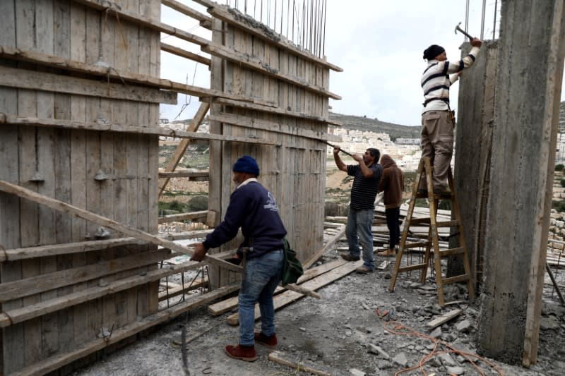 Palestinian labourers work at a construction site in the Israeli settlement of Ramat Givat Zeev in the Israeli-occupied West Bank