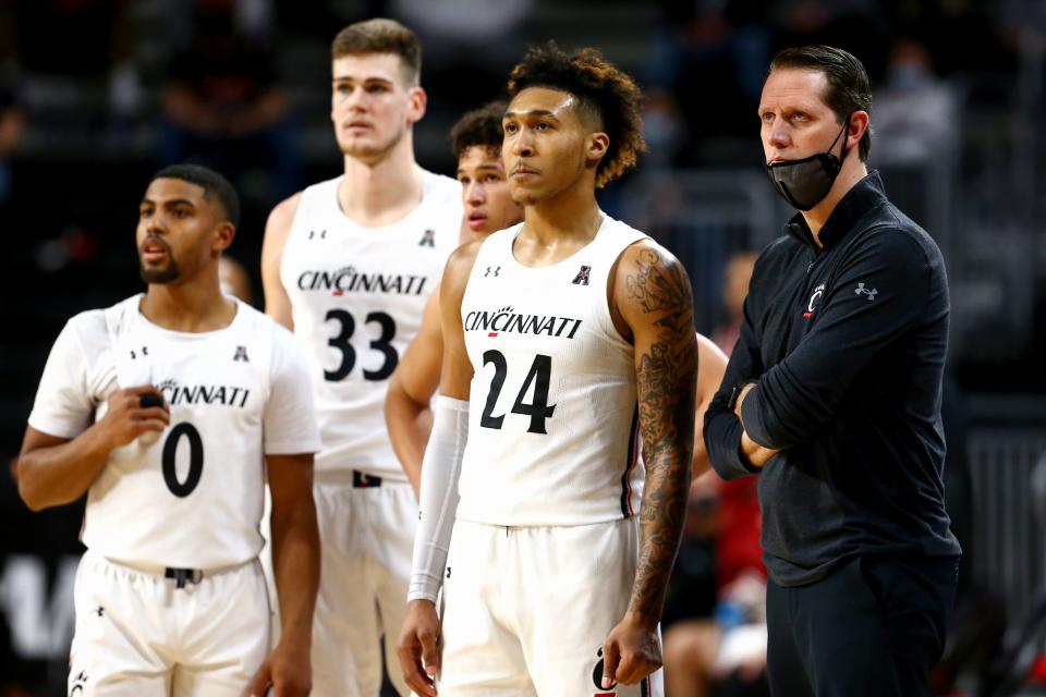 John Brannen and Cincinnati Bearcats players watch technical free throws in the second half of the game against Temple on Feb. 12 at Fifth Third Arena in Cincinnati. The Cincinnati Bearcats won the game, 71-69.