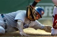 Toronto Blue Jays' Brett Lawrie slides safely at home on a single hit by Colby Rasmus as Boston Red Sox catcher Jarrod Saltalamacchia, right, tries to make the play in the eighth inning of a baseball game at Fenway Park, in Boston, Sunday, July 22, 2012. The Blue Jays won 15-7. (AP Photo/Steven Senne)